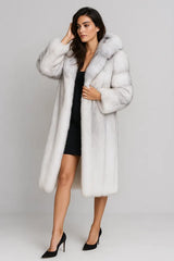 Full length view of women's white faux fur coat over black dress - luxury winter style