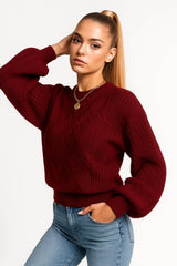 Women wearing a burgundy knit sweater with puff sleeves and gold necklace, stylish fall outfit
